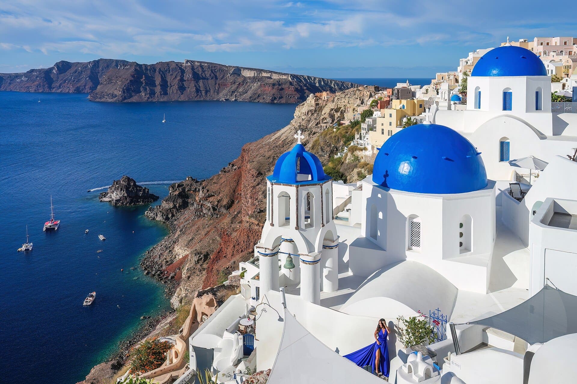 The three blue domes of Oia, Santorini, above the Aegean Sea
